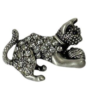 Pewter-tone cat holding yarn ball brooch with rhinestones.